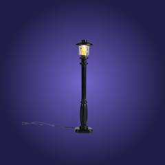 Black outdoor lamp post with a lit lantern on a dark blue background