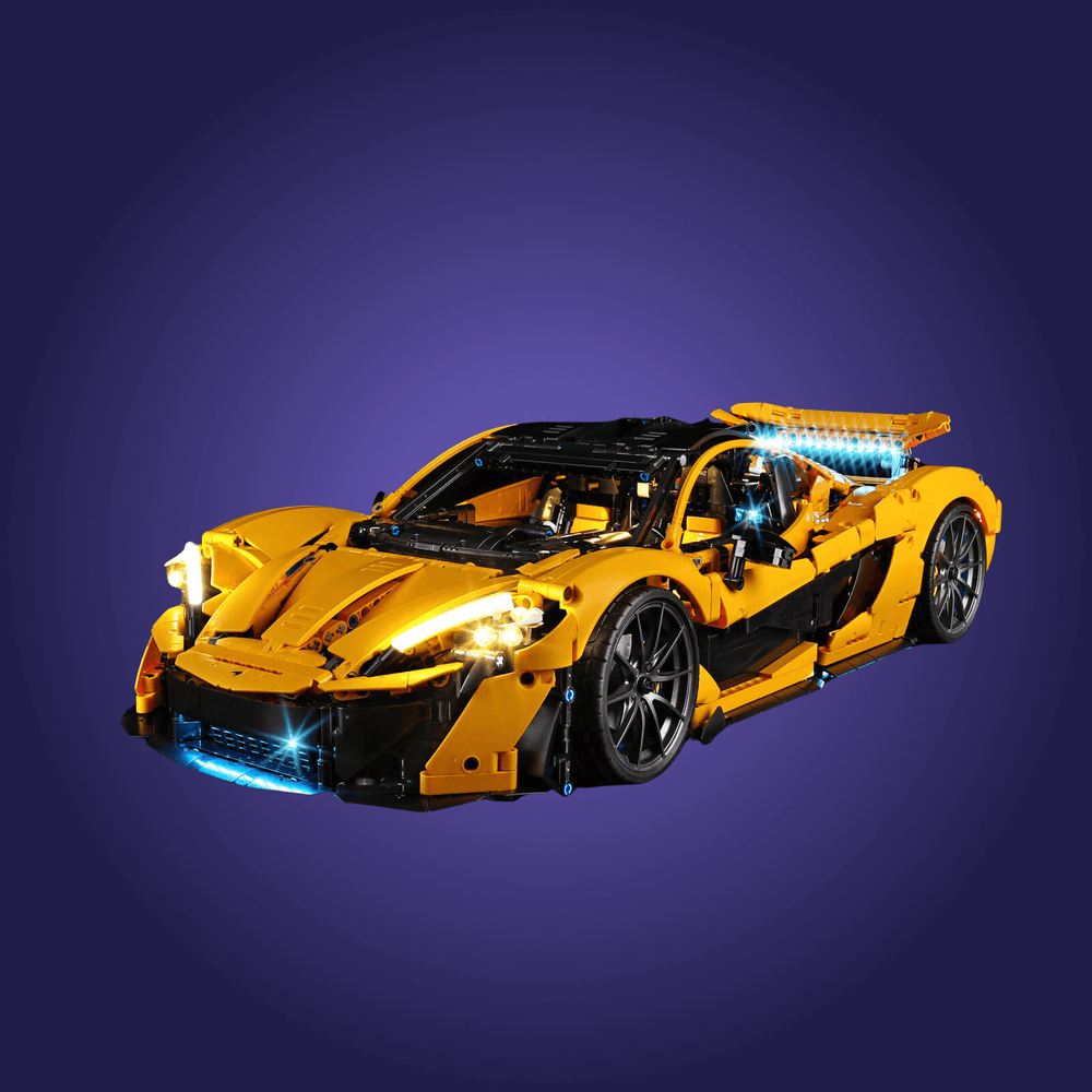 Yellow toy sports car with illuminated details on a dark blue background