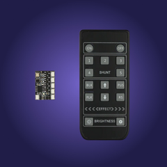 Black electronic remote control with buttons and a small circuit board on a purple background