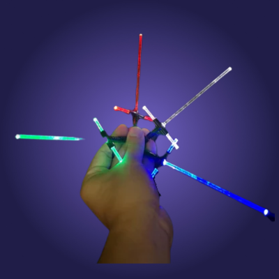 Hand holding a colorful LED stick toy against a dark background