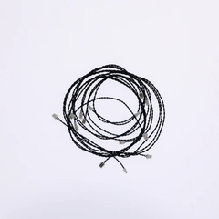Coiled black cable on a white background