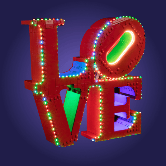 Colorful Lego 'LOVE' 31214 sculpture with illuminated lights on a dark background