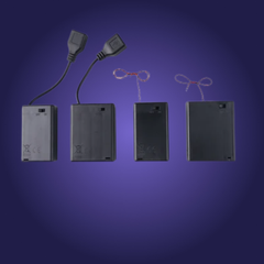 Set of electronic components including batteries, connectors, and wires on a blue background