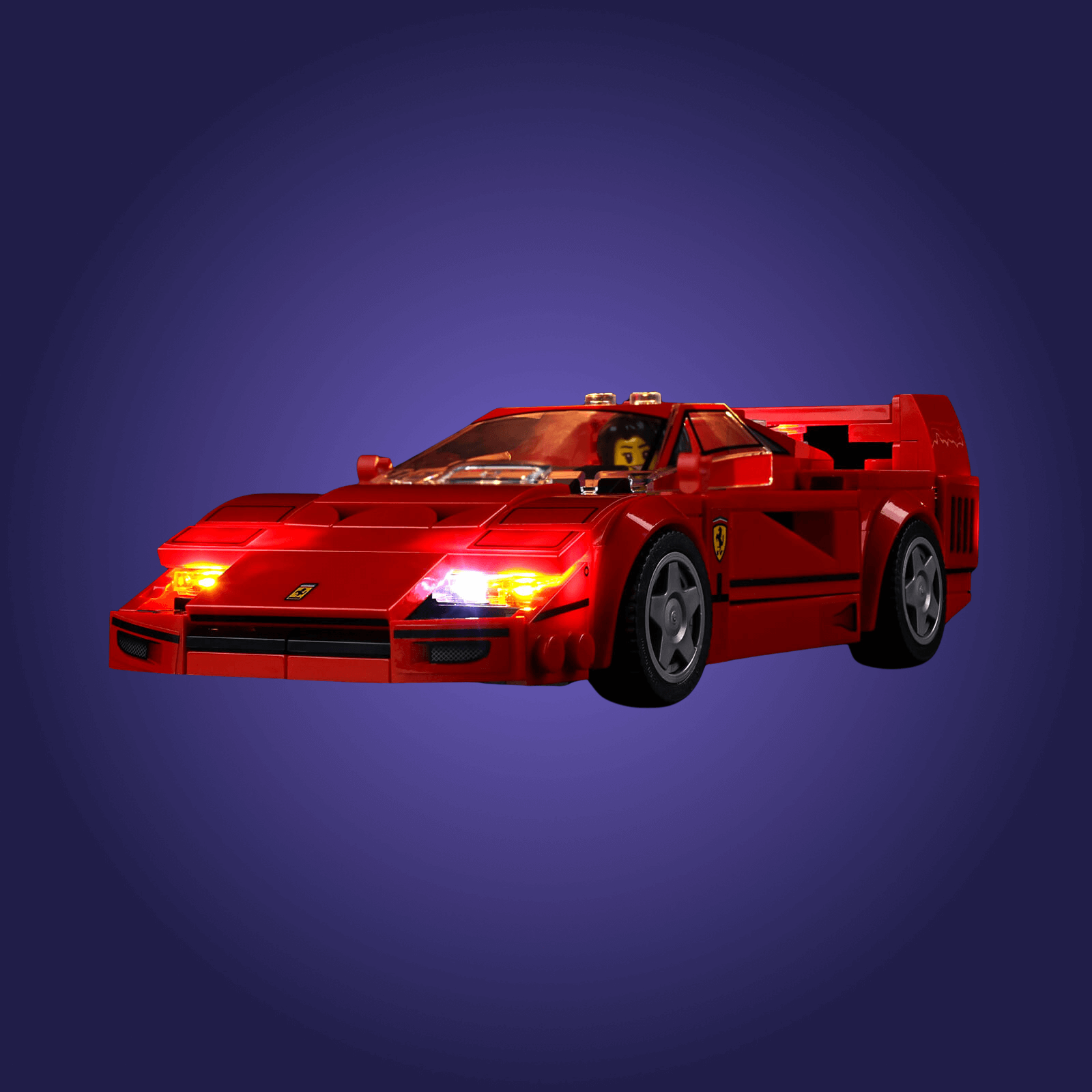 Red toy car with a Ferrari logo on a dark blue background